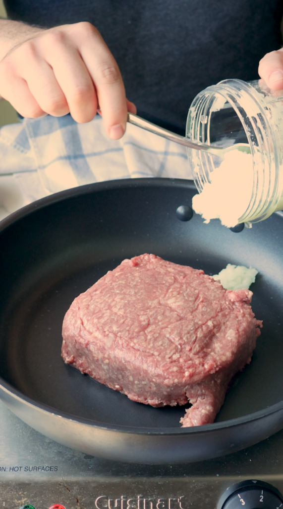  Begin by browning ground beef with a blended onion, minced garlic, no salt seasoning mix and salt. 